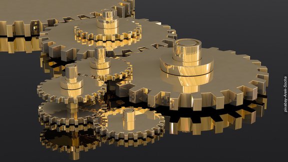 Goldene Zahnräder greifen ineinander