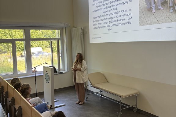 Mitarbeiterin referiert vor den werdenden Müttern im Hörsaal.